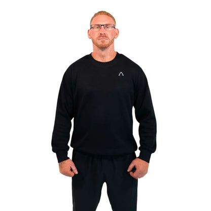 I AM FITNESS APPAREL black crewneck sweatshirt with small white diamond logo on chest and "Fitness Is My Life Style" graphic on back. Model wears glasses and black sweatpants.